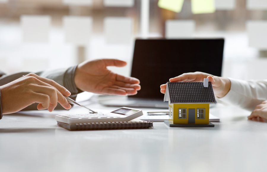 A model house and a calculator on a desk